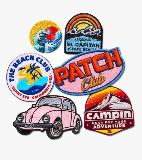 Branded merchandise photography of a set of colorful beach-themed embroidered patches arranged on a light background.