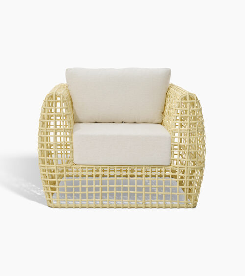 Furniture product photography of an open-weave rattan lounge chair with white cushions, front view.