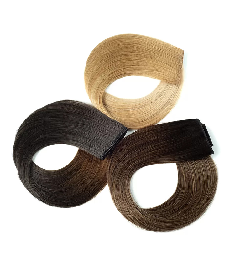 Hair extension photography of three rolled wefts in blonde, dark brown, and brown ombre shades, grouped flat lay on white.