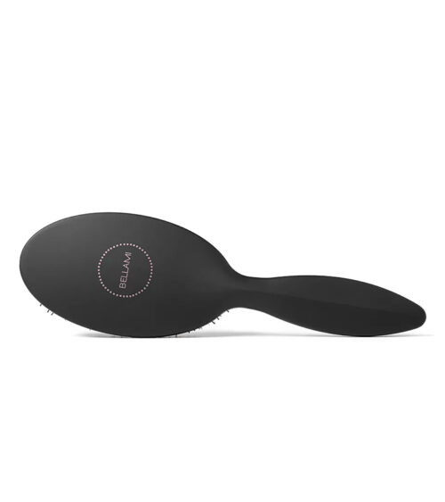 Hair tools product photography of a matte black detangling brush, angled top view on white.