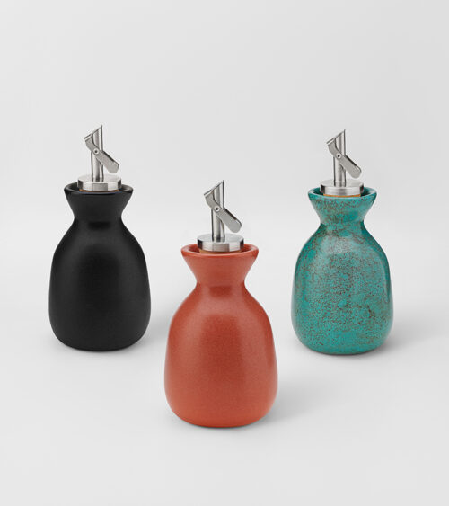 Home decor product photography of three ceramic oil pourer bottles in black, terracotta, and turquoise glazes.