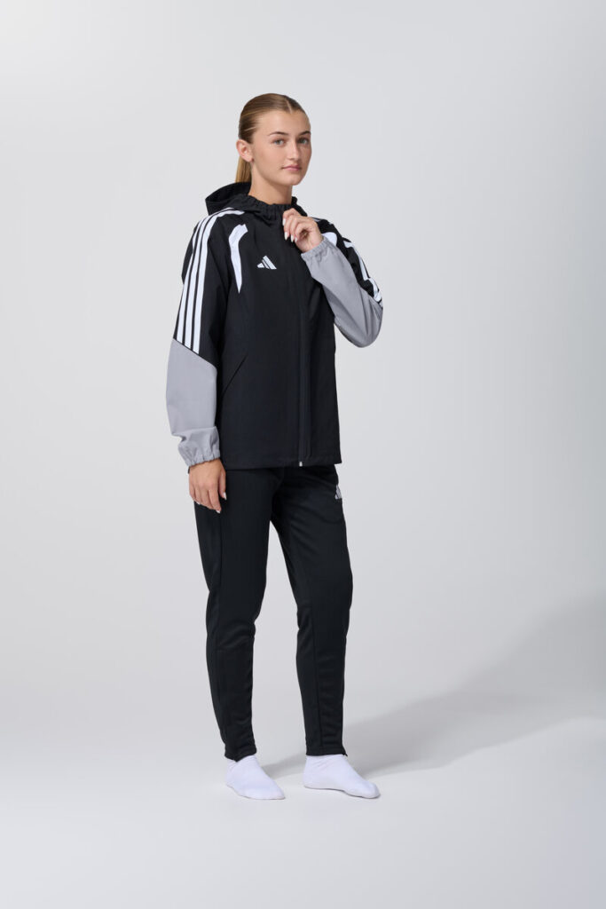 Female model in black and grey adidas track jacket and pants