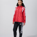 Female model in red adidas track jacket and pants