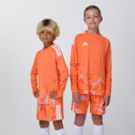 Two youth models in matching orange goalkeeper jerseys and shorts