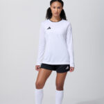 Female model in white long sleeve soccer jersey and white shorts