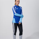 Female model in blue adidas track jacket and leggings