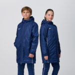 Two youth models in matching navy Nike puffer jackets and pants