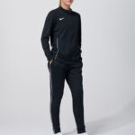 Male model in black Nike track jacket and pants