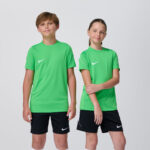 Two youth models in matching green Nike soccer jerseys