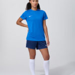 Female model in blue soccer jersey and shorts