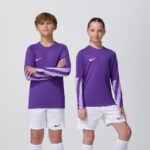 Two youth models in matching purple Nike goalkeeper jerseys