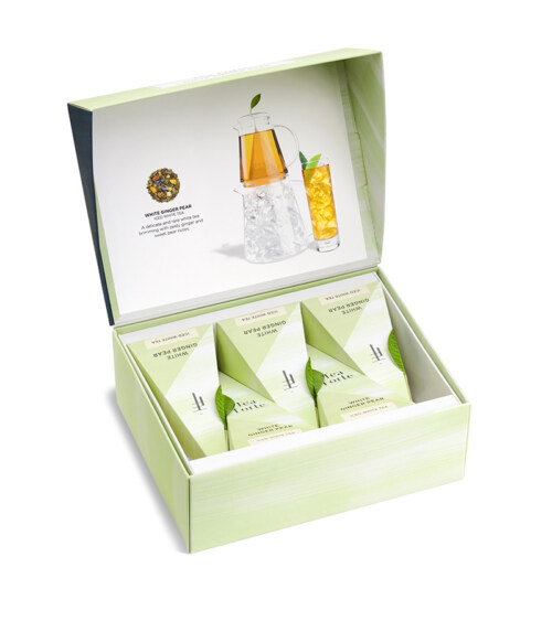 Professional product photography featuring a Tea Forte wellness gift set with premium tea sachets and tea bottle, photographed for an online store.