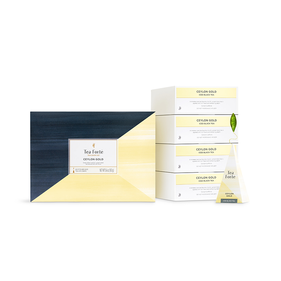 White background product photography of the Tea Forté Ceylon Gold iced tea collection with a large gift box, stacked refill boxes, and a pyramid infuser