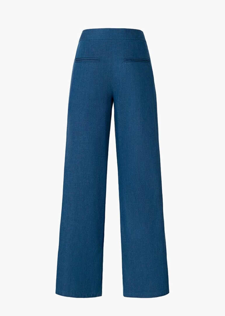 Flat lay product photography of blue wide-leg sailor trousers, back view showing welt pockets