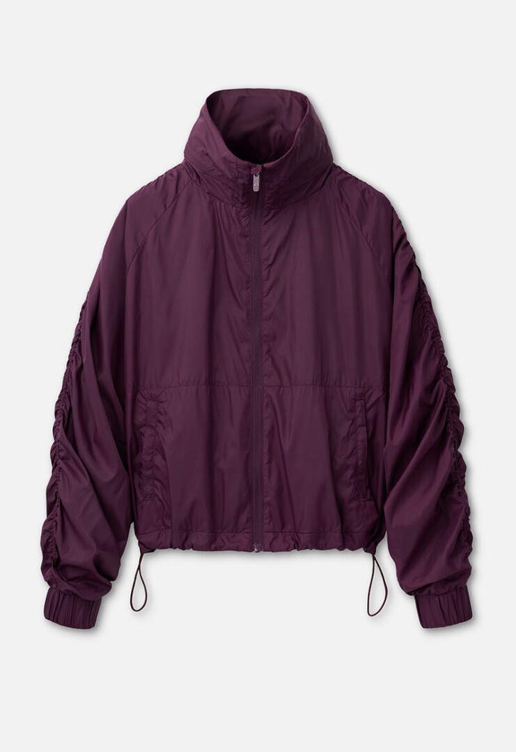 Product photography of a plum ruched-sleeve windbreaker jacket with a stand collar and drawcord hem, front view on white