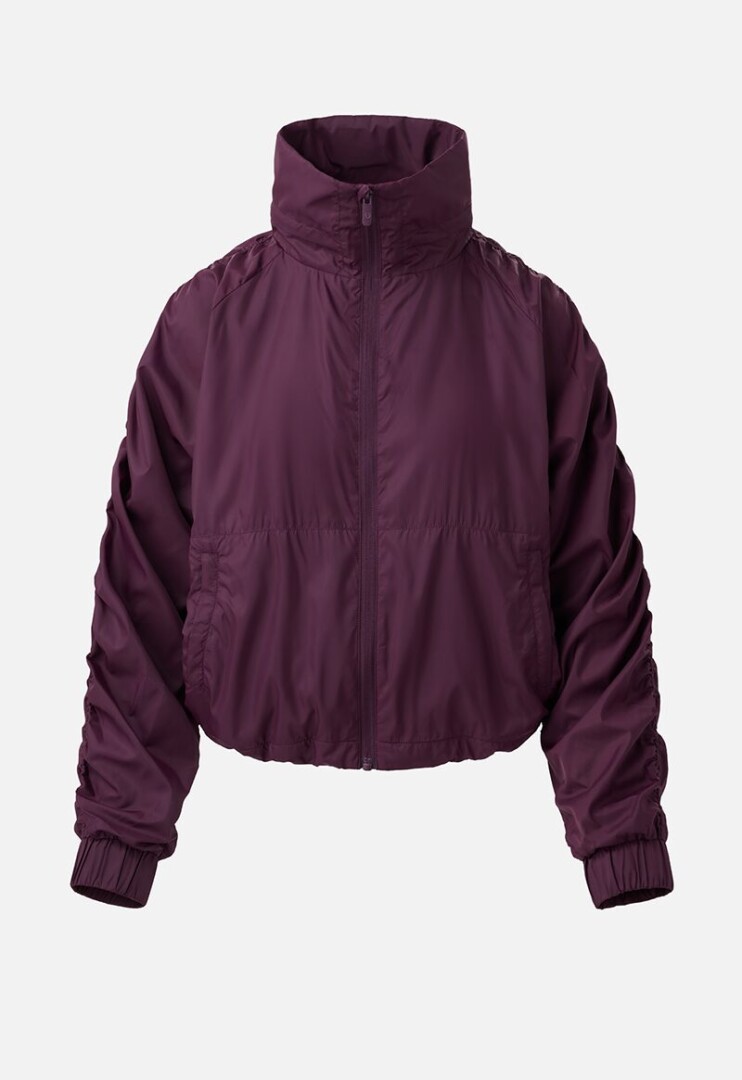 Product photography of a plum windbreaker jacket shown with the drawcord relaxed, front view on white