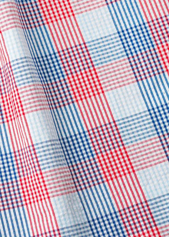 Fabric swatch close-up of a red, blue and white checked plaid cotton, folded to show the weave