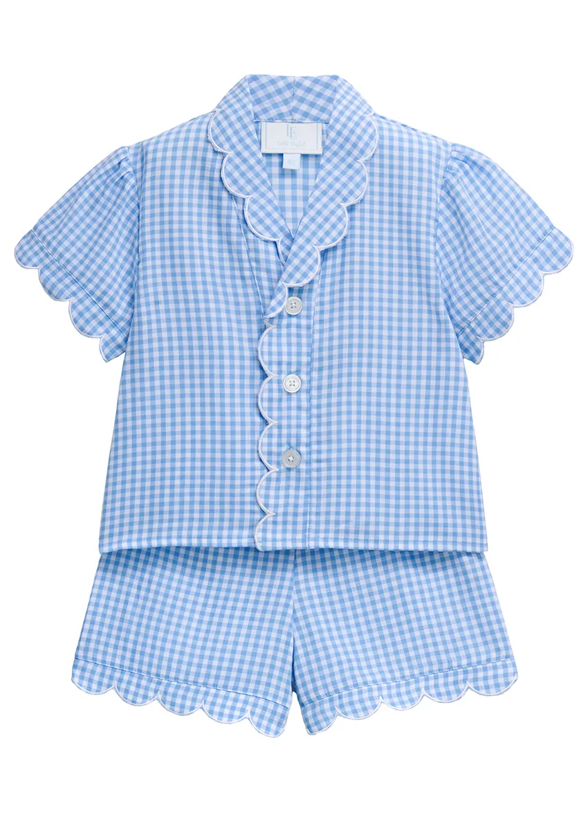 Blue gingham girls' pajama set with white scalloped trim on collar, sleeves and shorts, flat lay on white