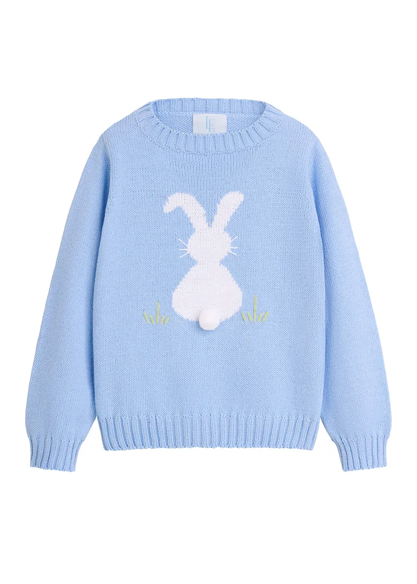 Light blue knit children's sweater with white intarsia bunny and pom-pom tail, styled flat lay on white