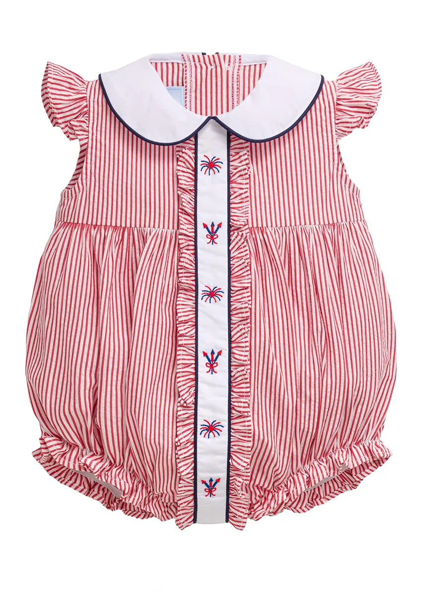 Red and white striped seersucker bubble with ruffled placket and embroidered fireworks, flat lay on white