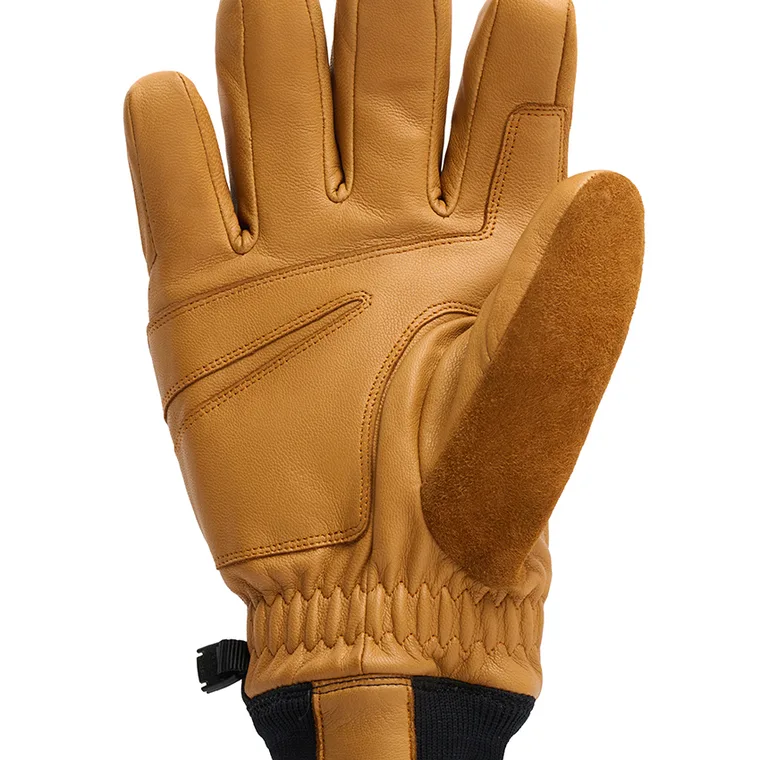 Close-up of the palm of a tan leather ski glove showing the suede thumb panel and stitching