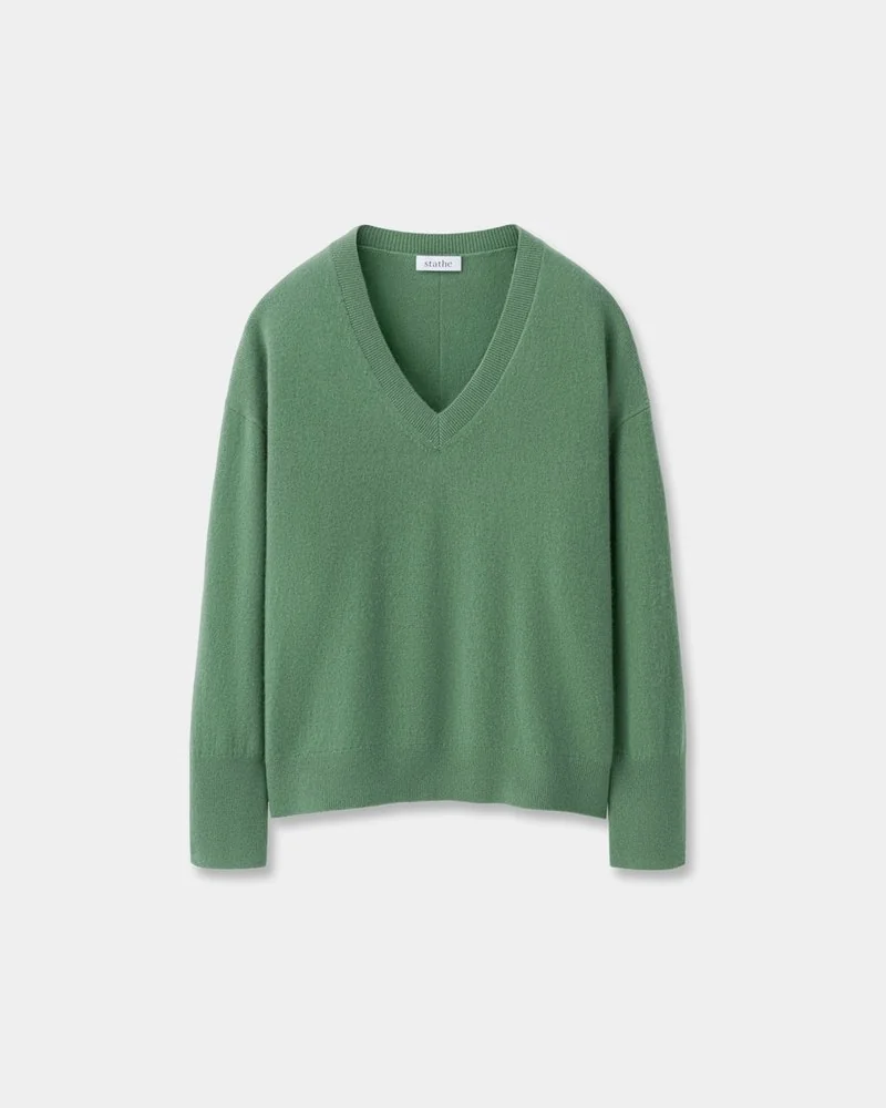 Flat lay of a green cashmere V-neck sweater