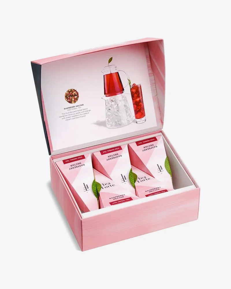 Open pink tea gift box with pyramid tea infusers