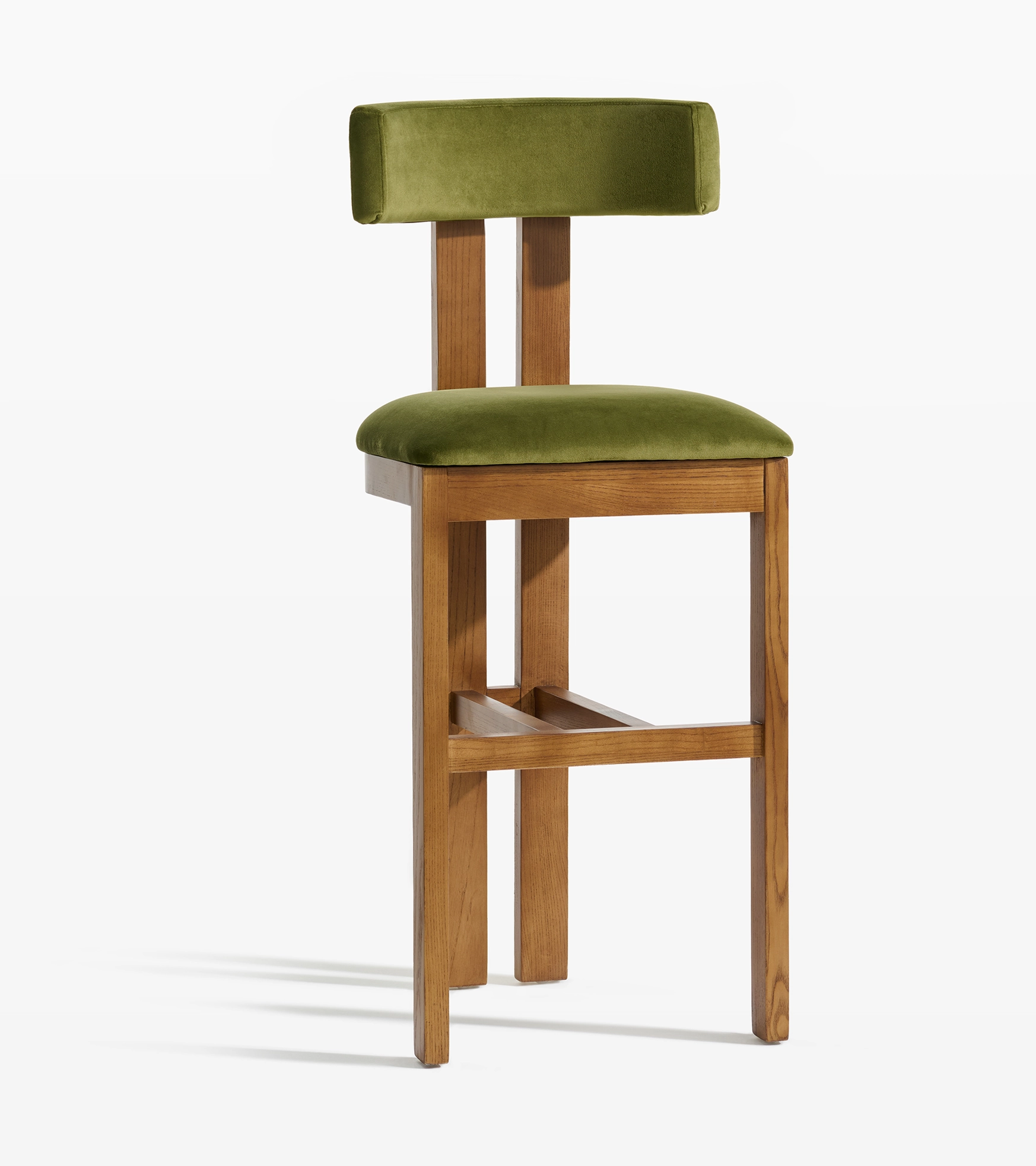 Furniture photography of a wooden bar stool with green velvet upholstery