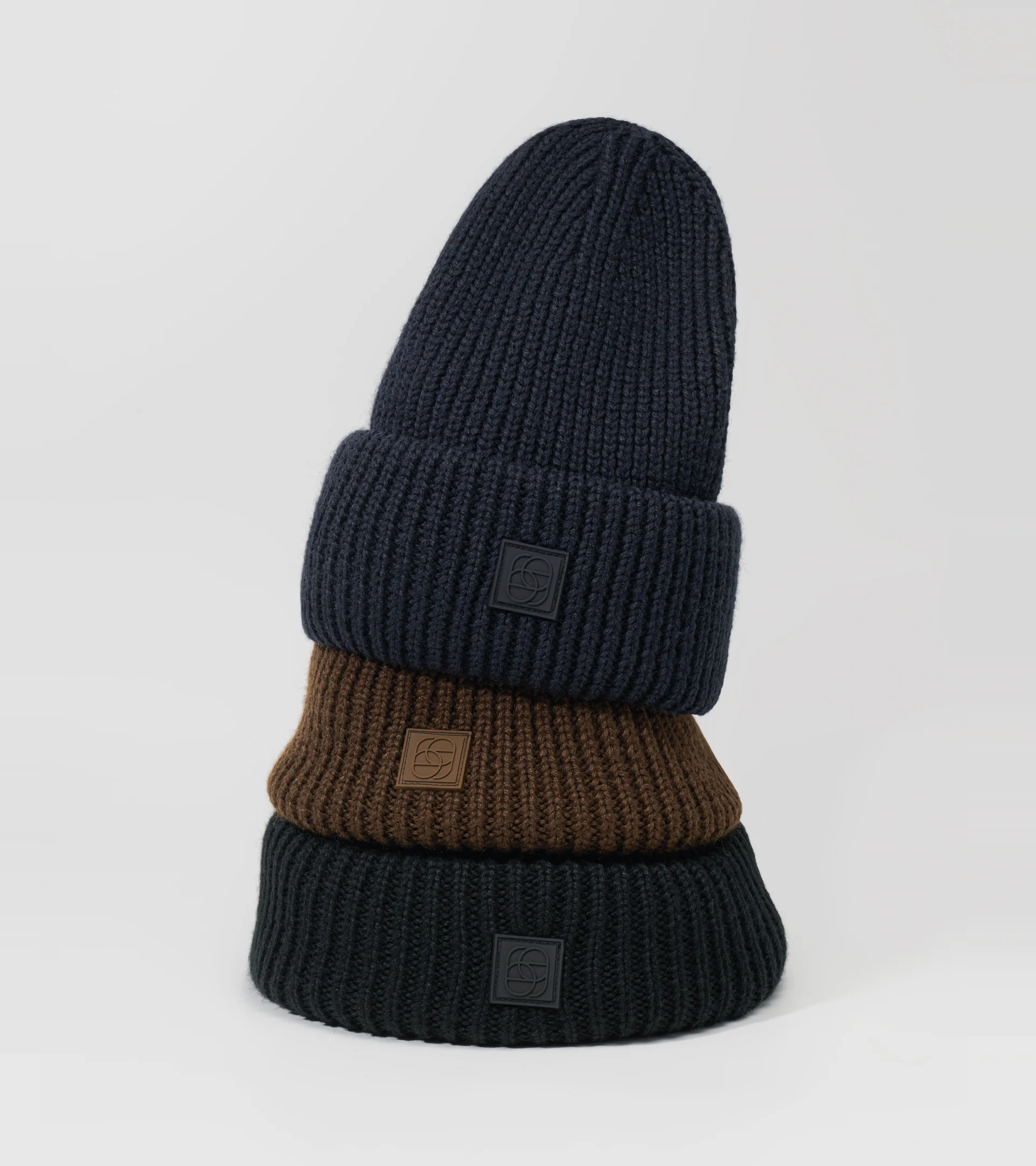 Hat photography of three stacked ribbed knit beanies