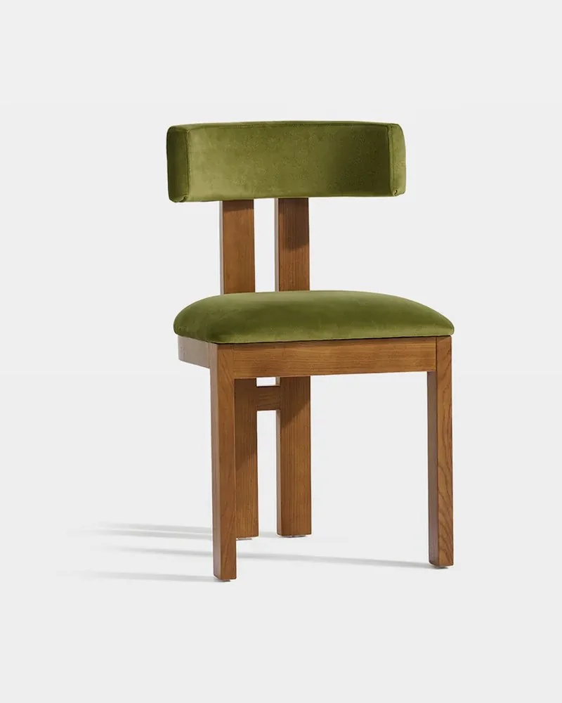 Green velvet dining chair with a wooden frame