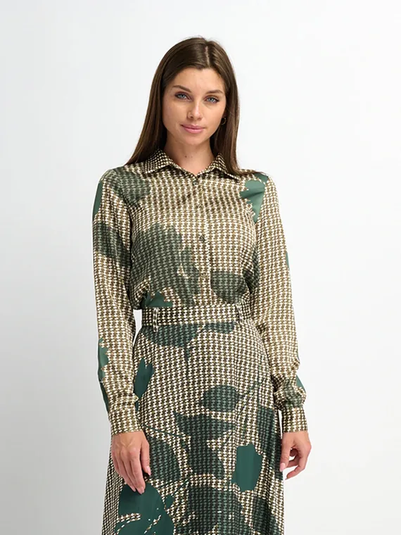 Model in a green and cream printed satin shirt, three-quarter length