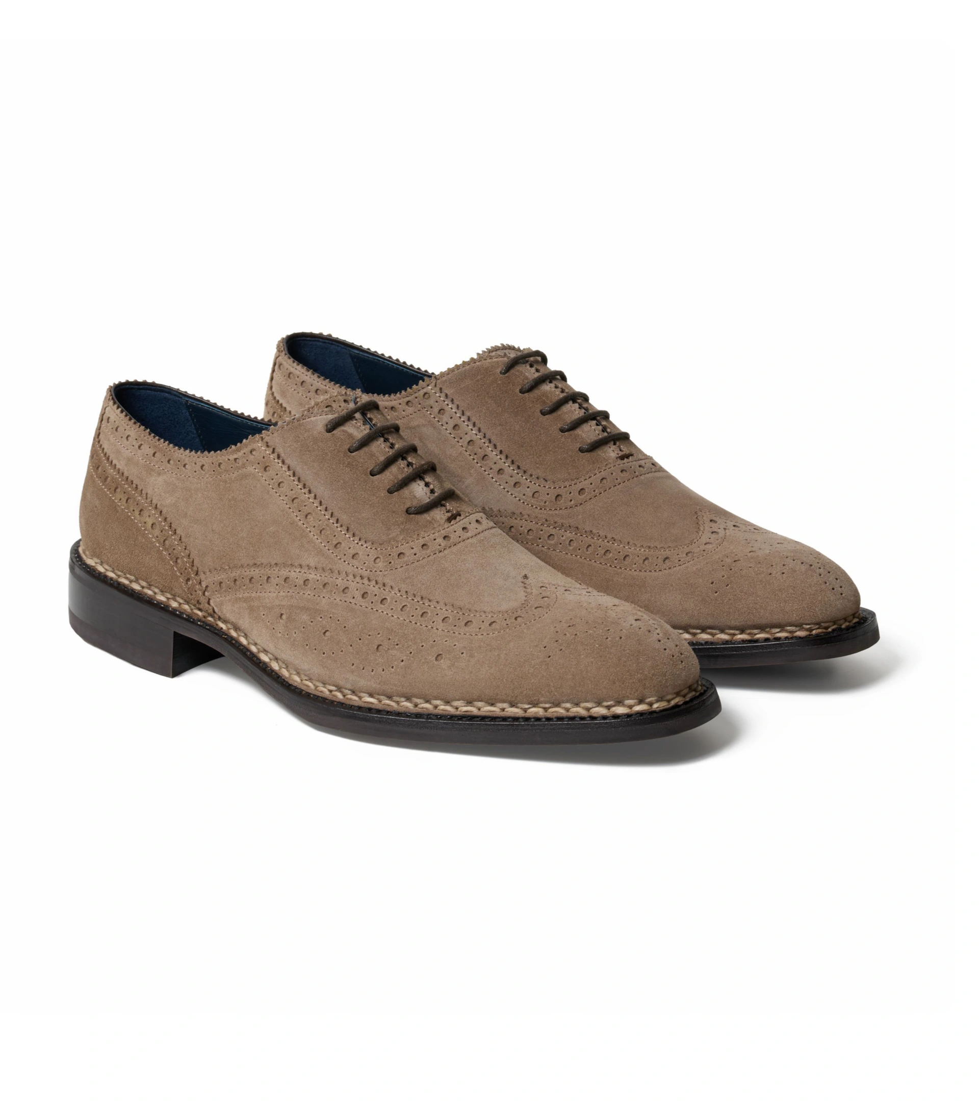 Shoe photography of a pair of taupe suede wingtip brogues