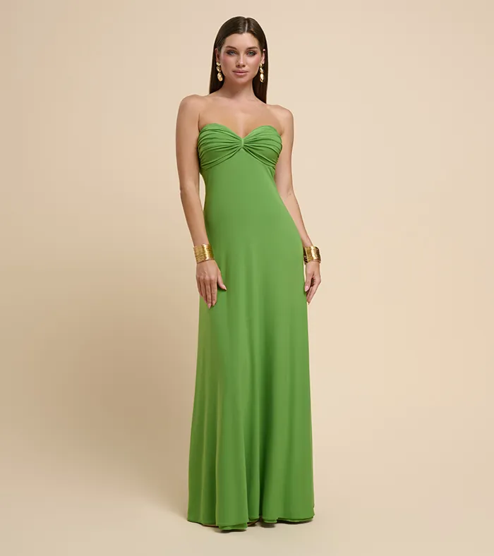 On-model photography of a green strapless ruched gown with gold cuff bracelets