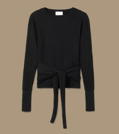 Flat lay photography of a black knit sweater with waist tie detail photographed for fashion apparel photography.