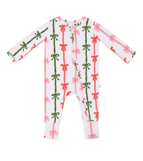 Flat lay photography of a white baby romper with pink and red bow stripe print