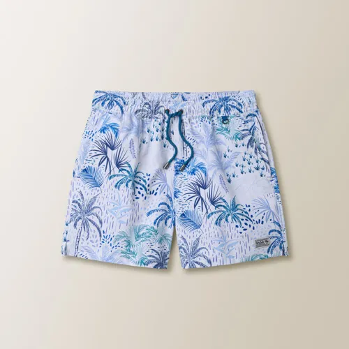Flat lay photography of tropical print men's swim trunks for apparel product photography by Shootify.