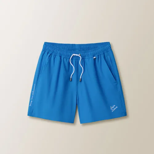 Flat lay photography of bright blue men's swim trunks for e-commerce clothing photography.
