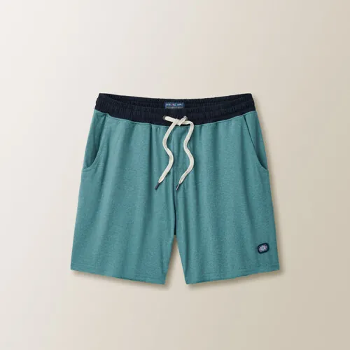 Flat lay photography of teal men's swim shorts photographed for apparel product photography.