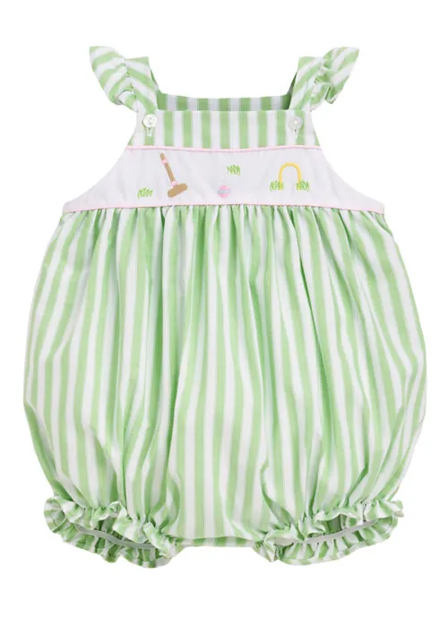 Flat lay photography of a green striped baby romper for online retail apparel photography.