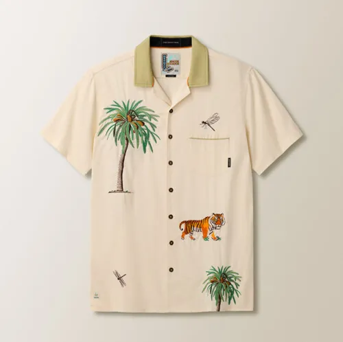 Flat lay photography of a cream tropical print button-down shirt for e-commerce apparel photography.