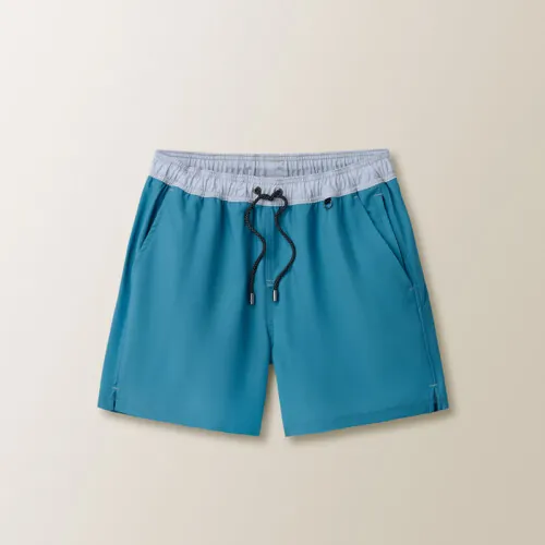Flat lay photography of blue men's swim shorts photographed for e-commerce apparel photography.
