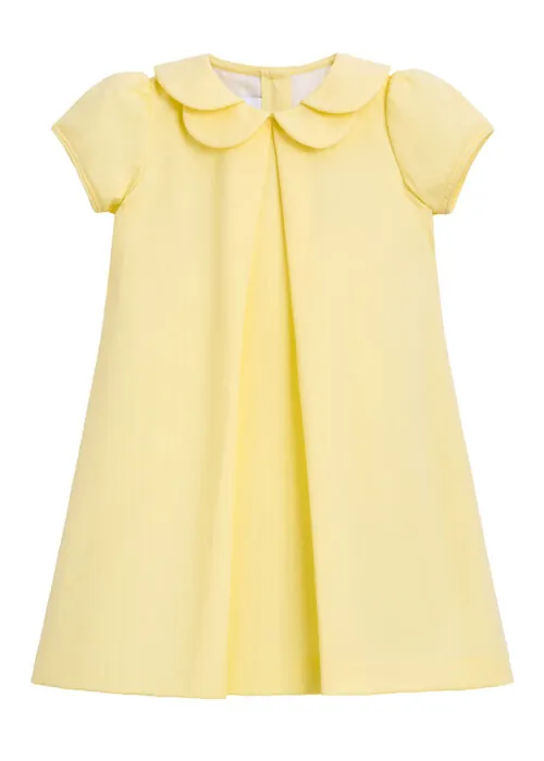 Flat lay photography of a yellow girls dress photographed for online retail children's apparel photography.