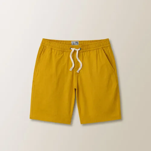 Flat lay photography of yellow men's swim shorts photographed for e-commerce clothing photography.