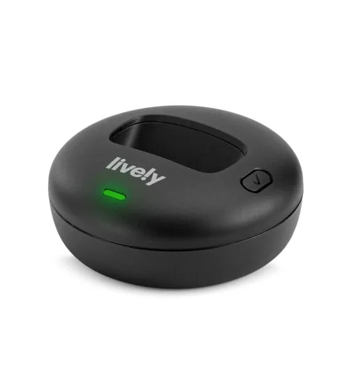 Product photography of a round black charging dock, three-quarter view