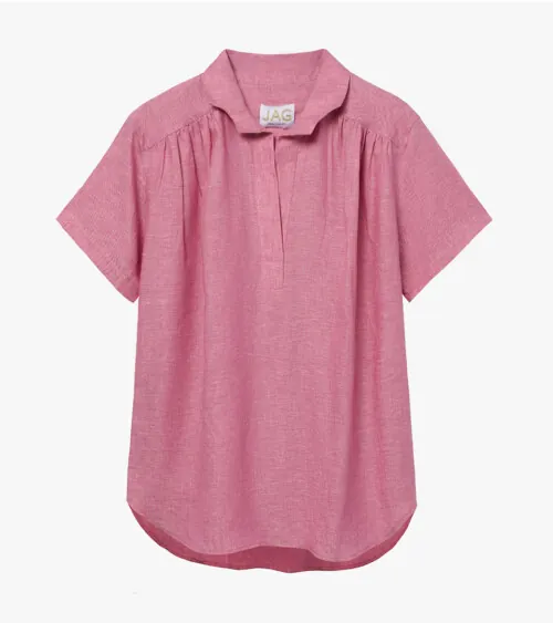 Flat lay photography of a rose pink women's short-sleeve blouse photographed for apparel product photography.