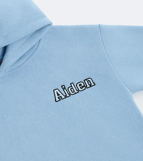 Macro detail photography of name embroidery on a light blue kids hoodie