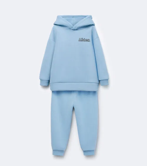 Flat lay photography of a light blue children's hoodie and jogger set photographed for e-commerce apparel photography.