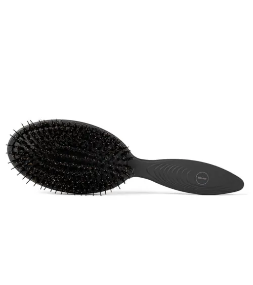 Black paddle hairbrush with boar bristles shown bristle-side on white background, beauty product photography