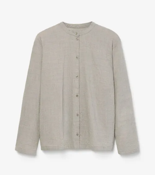 Flat lay photography of a beige button-front cardigan for online retail apparel photography.