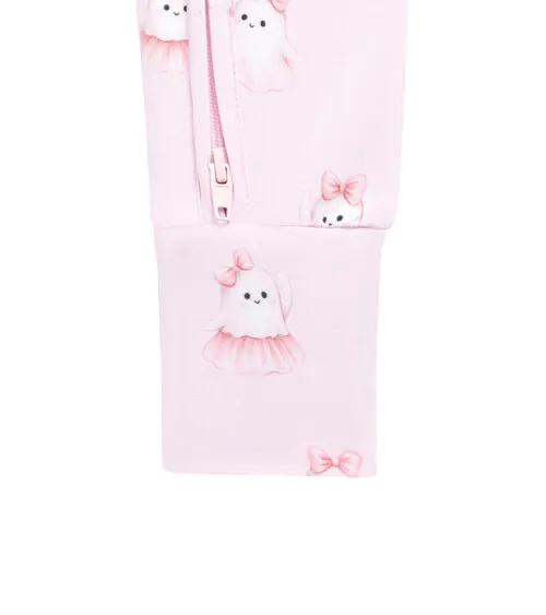 Macro detail photography of a pink baby garment zipper with bow-print fabric